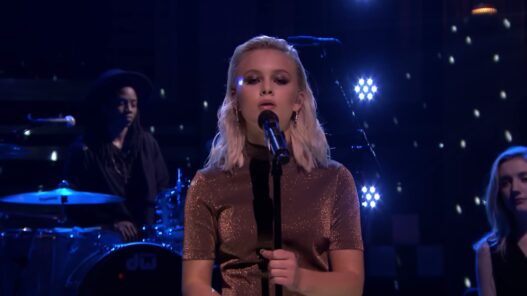 Zara Larsson performs Never Forget You live on The Tonight Show Starring Jimmy Fallon with a dramatic close-up under blue stage lighting