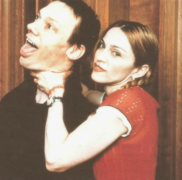 Madonna wrapping an arm around William Orbit as they face the camera