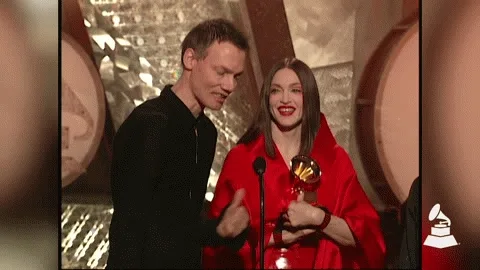 William Orbit standing beside Madonna as she holds the Grammy for Ray of Light