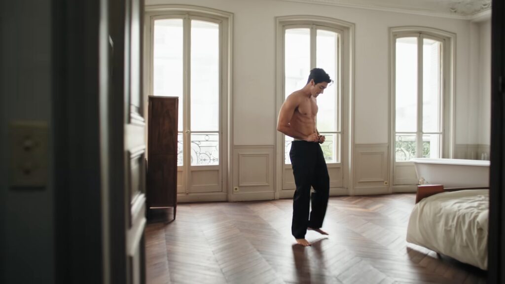 Taylor Zakhar Perez standing topless in a Paris flat during the Lacoste shoot