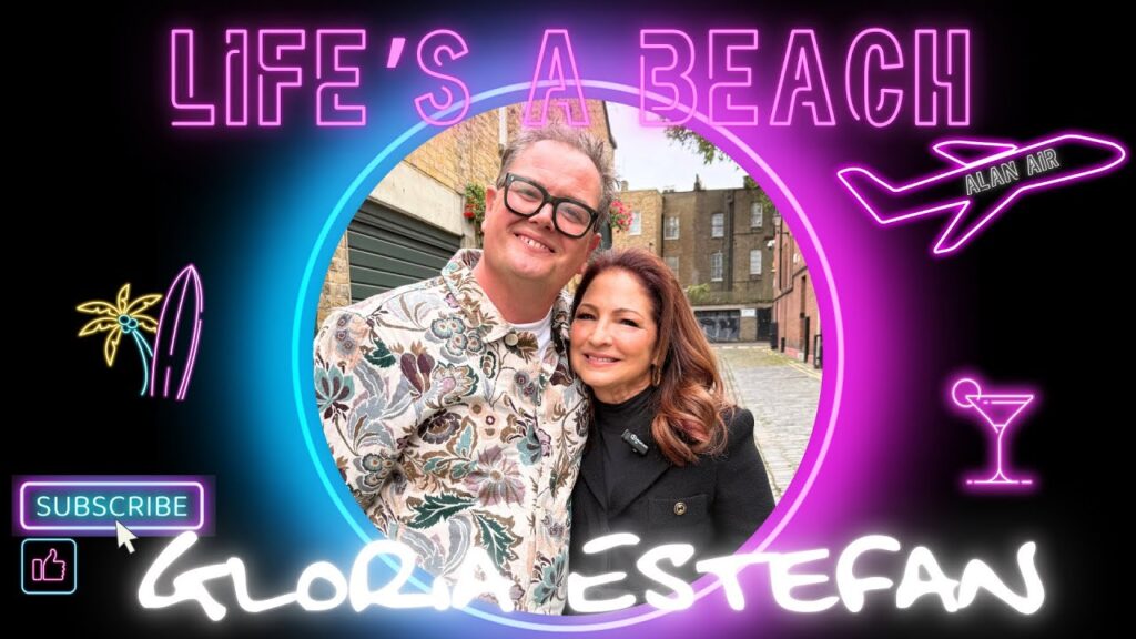 Gloria Estefan and Alan Carr chatting on beach set for Life’s A Beach