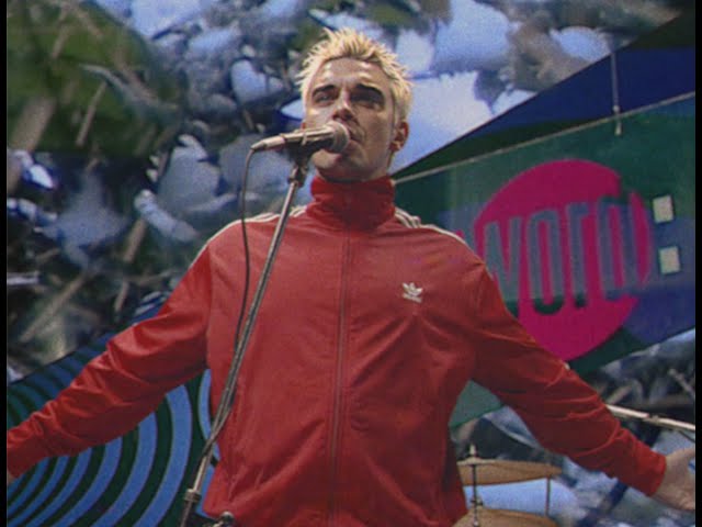 Robbie Williams performing “Pretty Face” in retro 1990s Britpop style