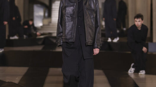 Model wearing Y‑3 FW26 runway look at Palais d’Iéna