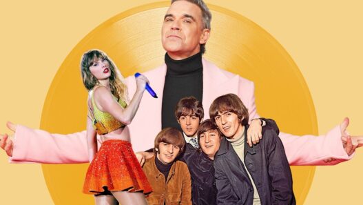 Robbie Williams celebrating his record‑breaking 16th U.K. No. 1 album