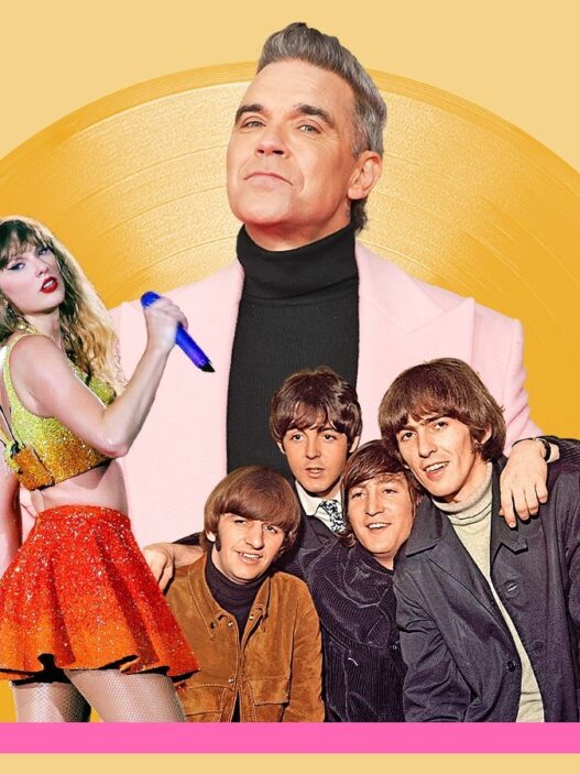 Robbie Williams celebrating his record‑breaking 16th U.K. No. 1 album