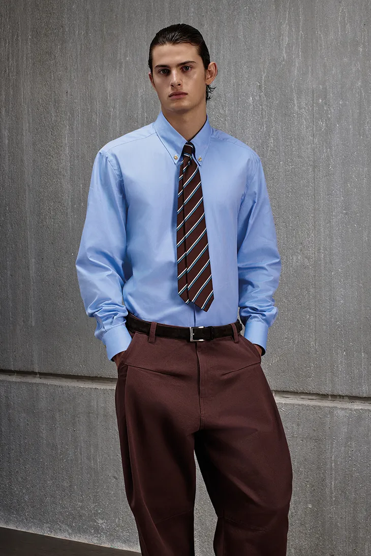 KNT Autumn Winter 2026/2027 menswear look featuring tailored outerwear and technical knitwear.