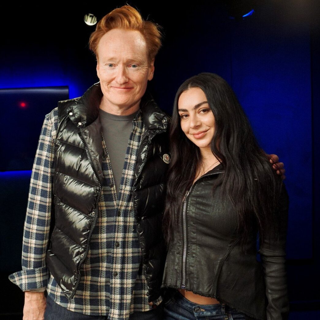 Charli XCX chatting with Conan O’Brien during podcast appearance