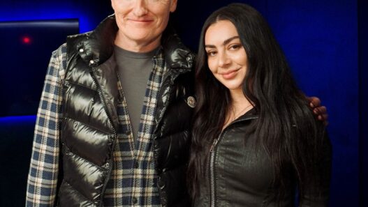Charli XCX chatting with Conan O’Brien during podcast appearance