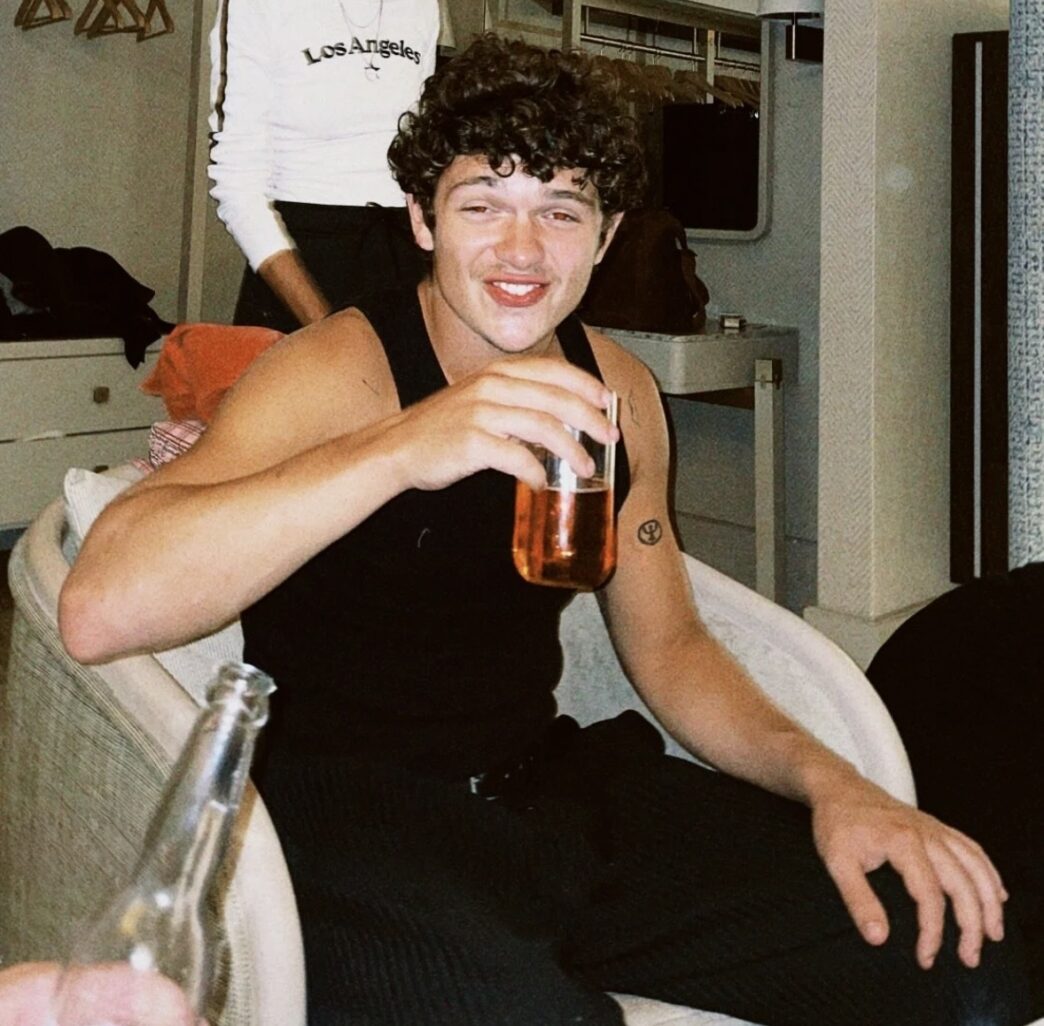 Noah Jupe posing during the “Hamnet” promo tour, showcasing his sharp and modern fashion style.