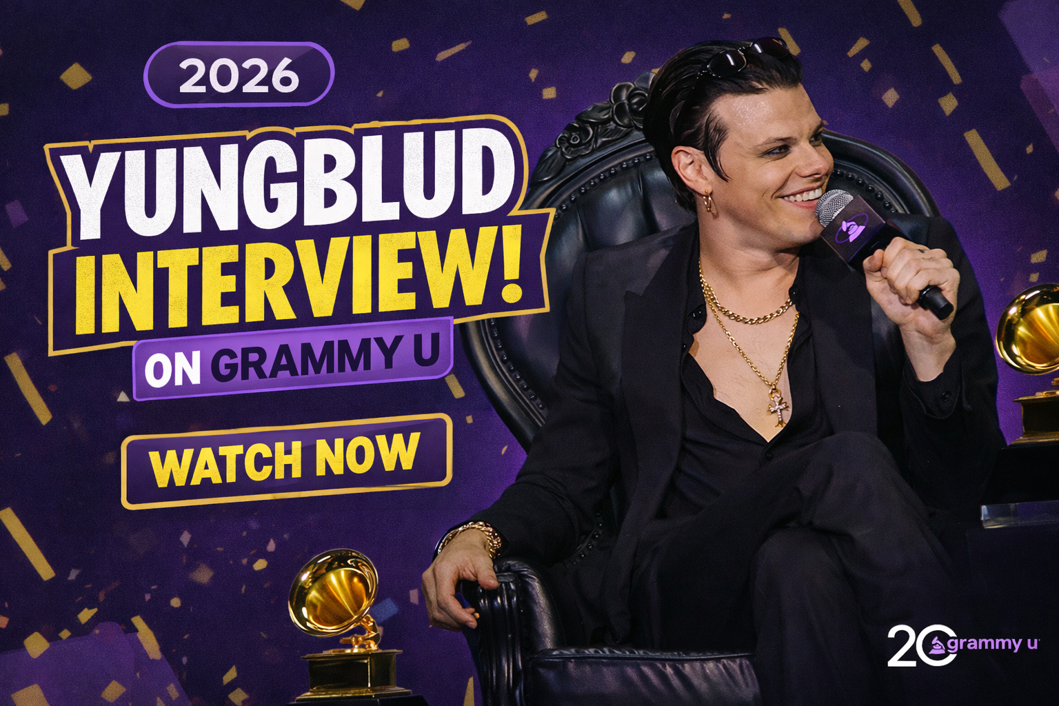 YUNGBLUD speaks on stage during a GRAMMY U interview in 2026, seated in a black armchair and holding a microphone beside GRAMMY trophies.