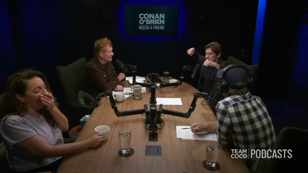 Conan O’Brien recording his podcast with Denis Leary and the Team Coco crew in a studio setting