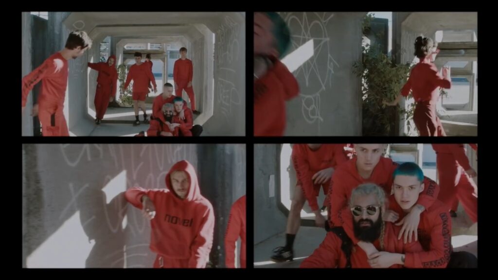 NOV3L in a still from the “To Whom It May Concern” official video, featuring the band’s minimalist, post‑punk visual aesthetic.