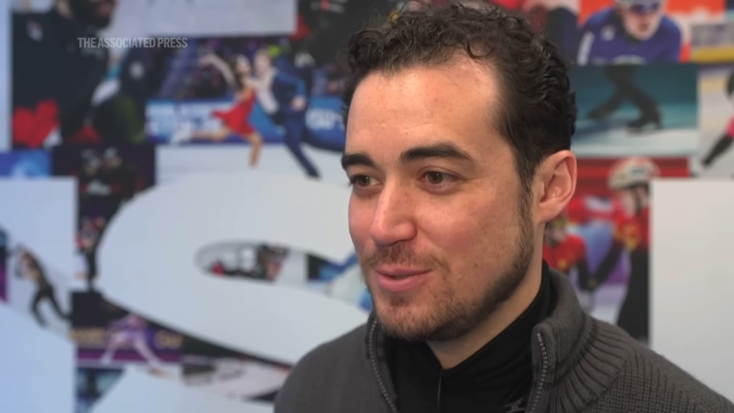 Jordan Cowan filming on the ice as the first Olympic on‑ice camera operator.