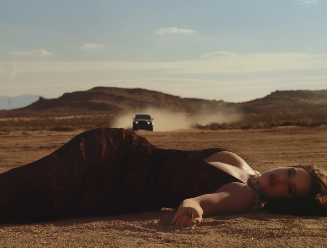 Rosalía performing in moody desert visual