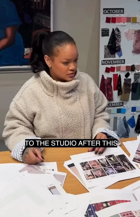 Rihanna reviewing artwork and aesthetics during a Savage X Fenty meeting in her “A Night in the Life” Reel