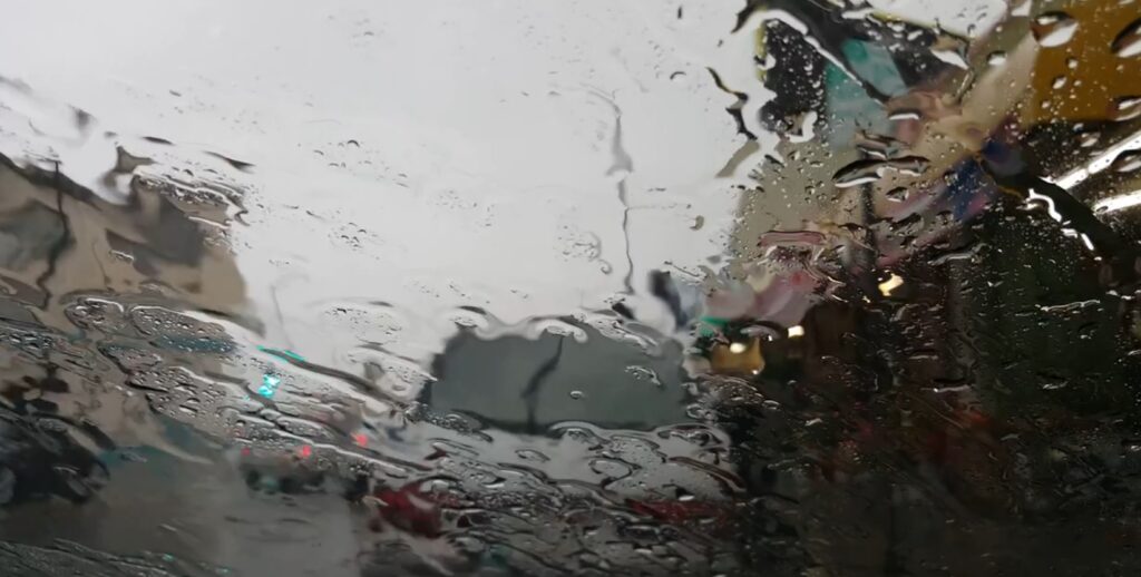 Heavy rain blurs a car windshield in Los Angeles during a storm.