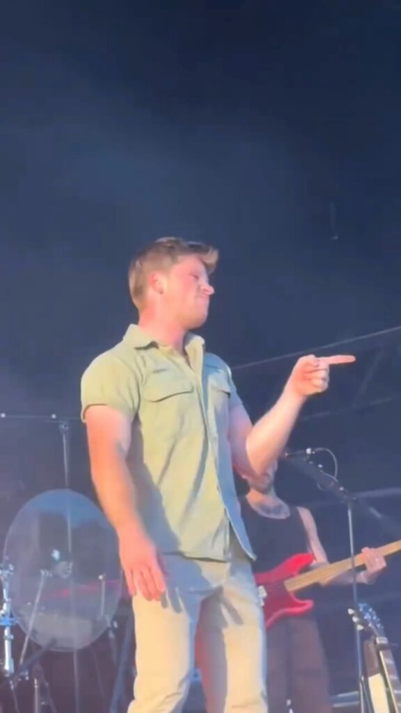 Robert Irwin singing along to Sally, When the Wine Runs Out at Laneway Festival as he point to singer Role Model.