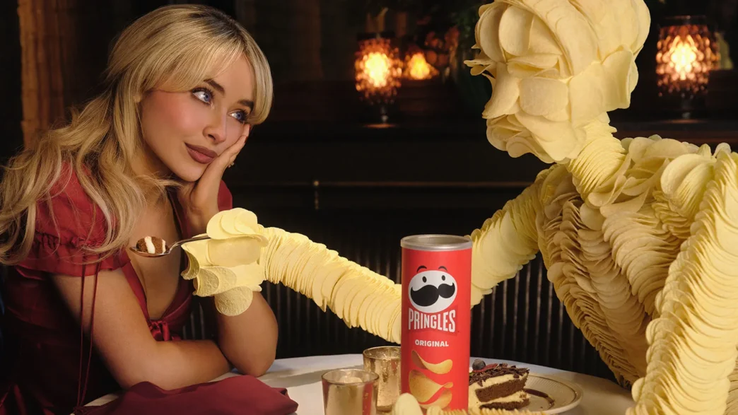 Sabrina Carpenter holding a Pringleleo's hand in her 2026 Super Bowl commercial