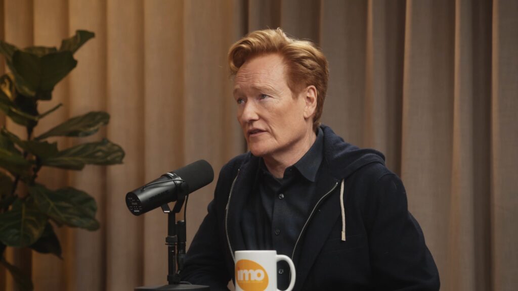 Conan O’Brien in conversation with Michelle Obama and Craig Robinson on the “IMO” podcast, reflecting on his journey and upcoming Oscars hosting.