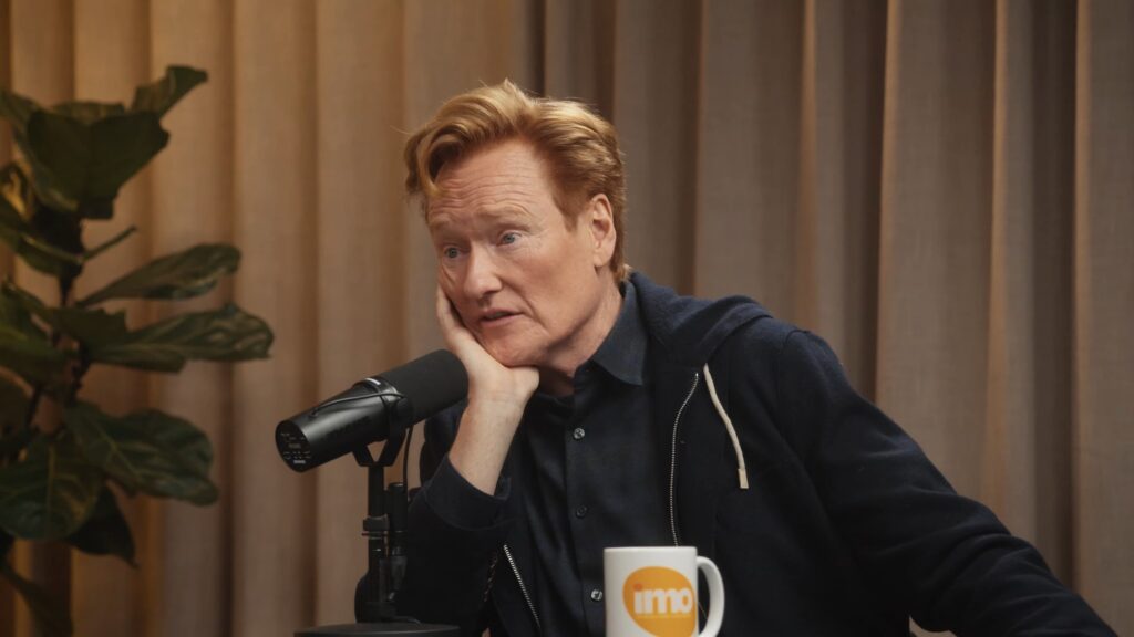 Conan O’Brien in conversation with Michelle Obama and Craig Robinson on the “IMO” podcast, reflecting on his journey and upcoming Oscars hosting.