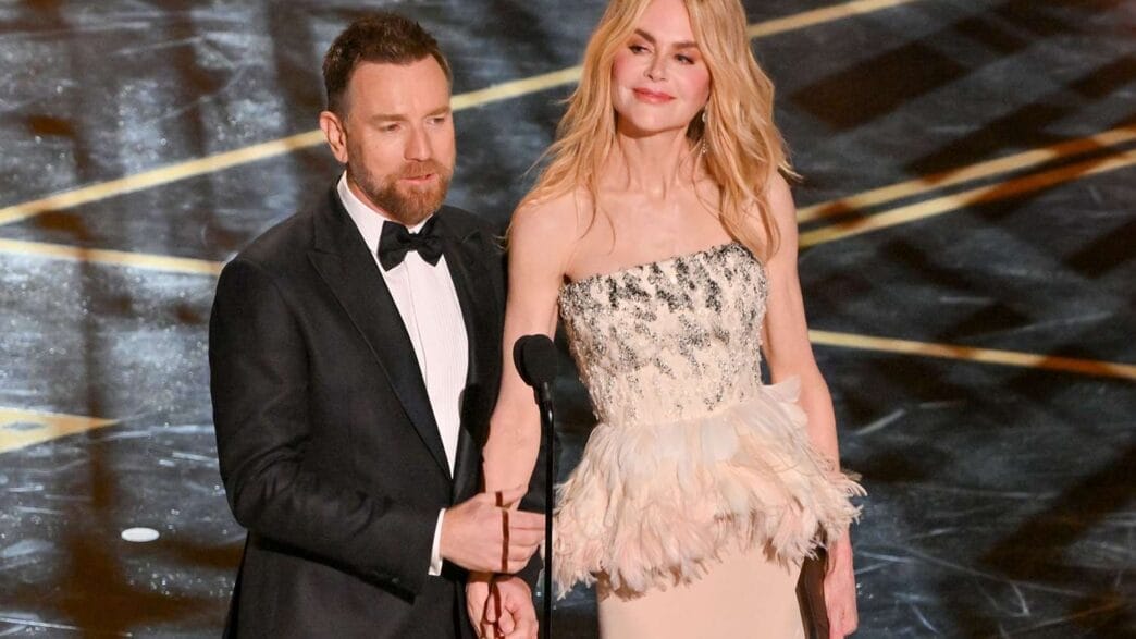 Nicole Kidman and Ewan McGregor standing together onstage at the 2026 Oscars, presenting under the ceremony’s bright lights in elegant formalwear.