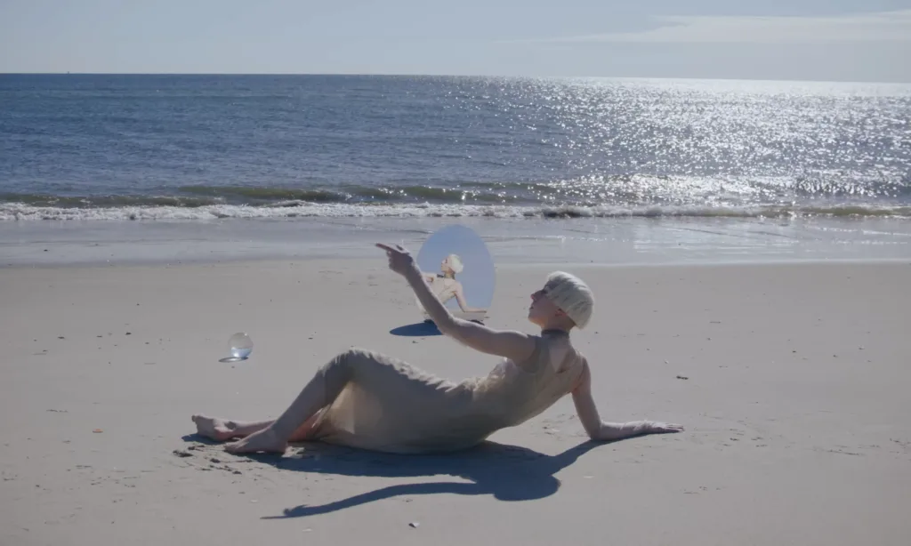 Rare DM in the Compliment music video with glam-punk visual energy