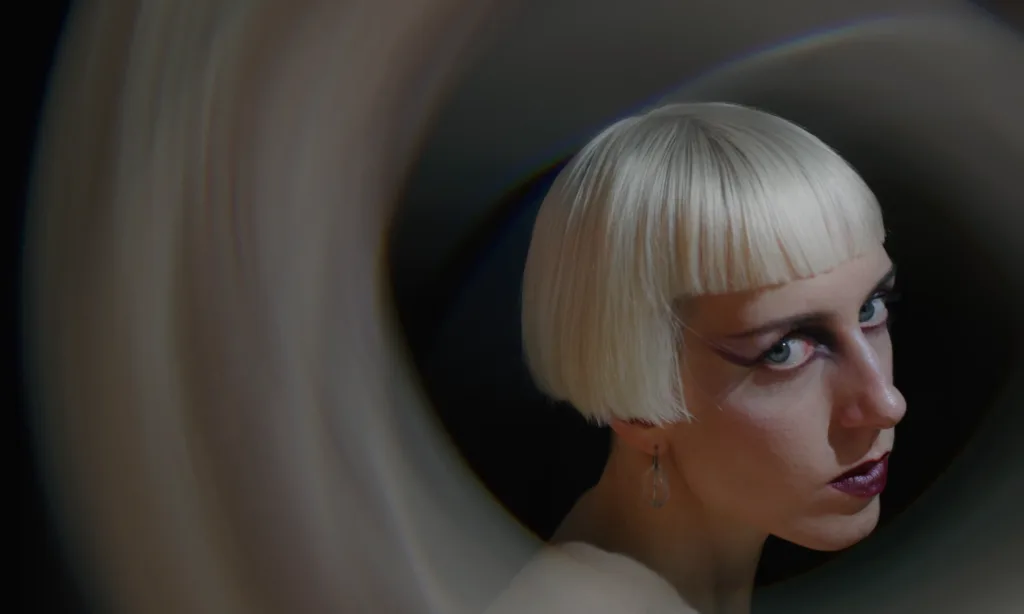 Rare DM in a darkwave scene from the Compliment music video