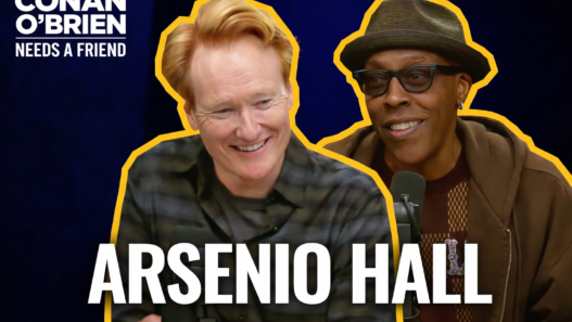 Arsenio Hall speaking into a microphone with Conan O’Brien during a Conan O’Brien Needs a Friend podcast episode