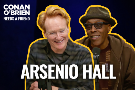 Arsenio Hall speaking into a microphone with Conan O’Brien during a Conan O’Brien Needs a Friend podcast episode