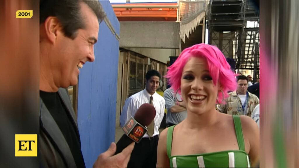 Singer P!nk with bright pink hair speaks to ET backstage during the 2001 “Lady Marmalade” video shoot.