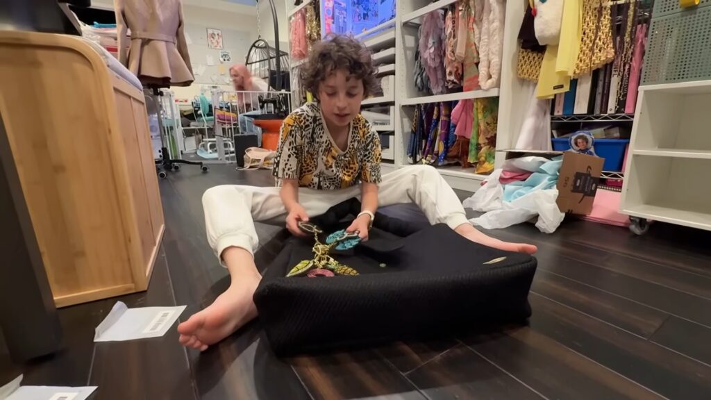 Max Alexander organizes embroidered charms and textiles inside his Los Angeles design studio.