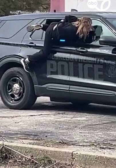 Viral clip of detainee wiggling out of patrol car.