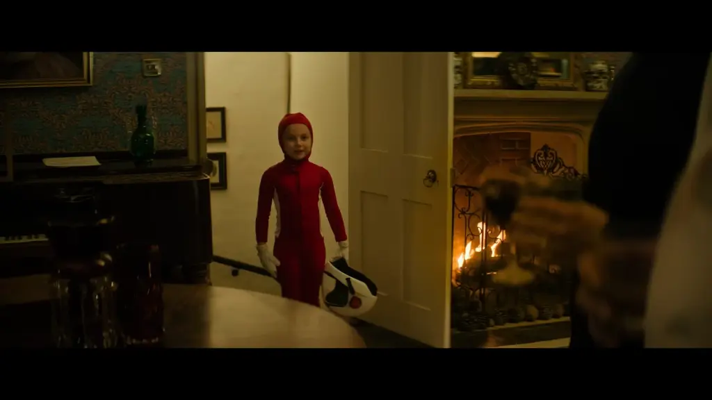 Child in a red costume entering a room in a scene from Preschool