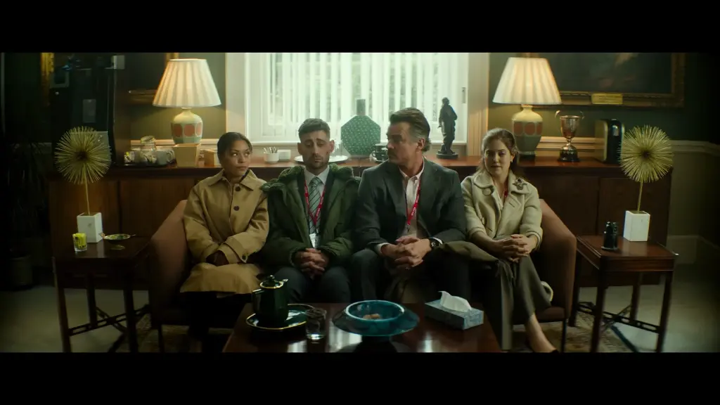 Four adults seated together in a waiting-room scene from Preschool