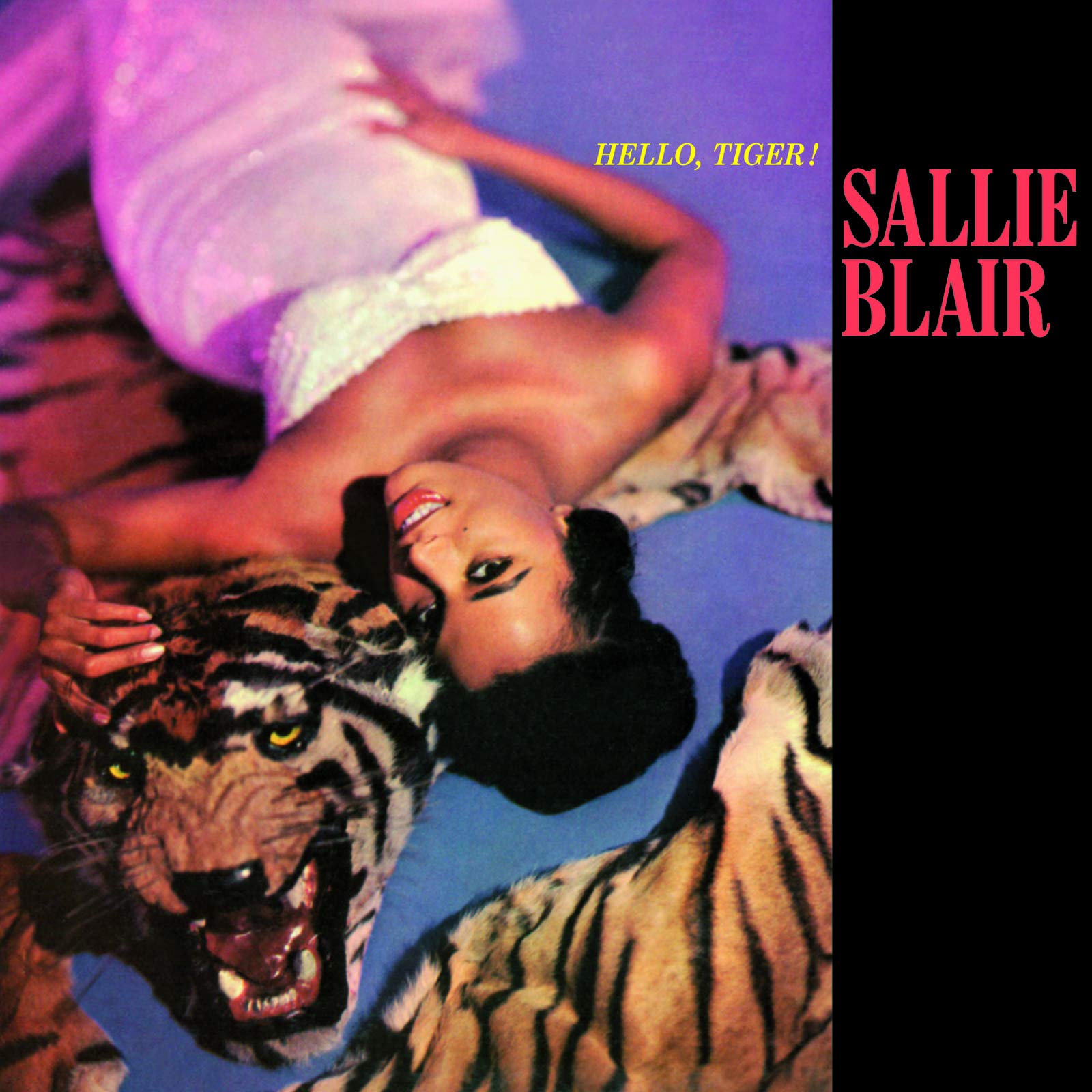 Poster for Salle Blair: a smiling woman in white atop a tiger rug with a tiger beside her, bold pink title on a black panel