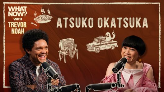 Trevor Noah and Atsuko Okatsuka talking during an episode of What Now? With Trevor Noah.