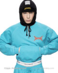 Model wearing a turquoise hoodie and pants with a black hooded balaclava; branded chest logo visible. Gosha Rubchinskiy unveils his bold new “PERESVET” campaign exploring athletic form.vGosha Rubchinskiy unveils his bold new “PERESVET” campaign exploring athletic form. Gosha Rubchinskiy unveils his bold new “PERESVET” campaign exploring athletic form.