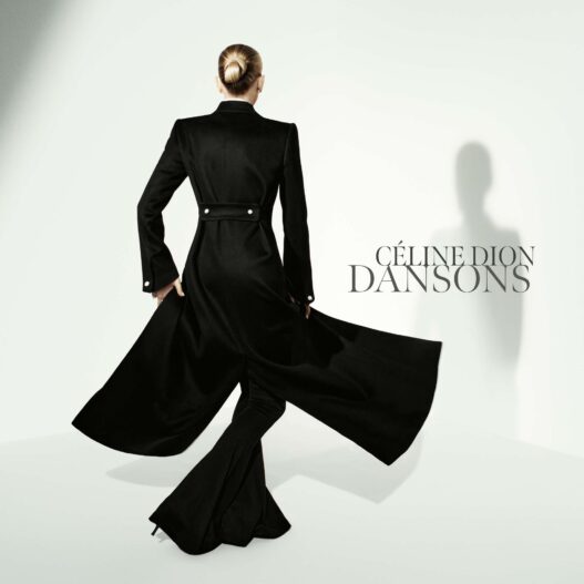 Back view of a woman in a long black coat with a flowing cape against a pale background; 'CÉLINE DION DANSONS' text on the right.
