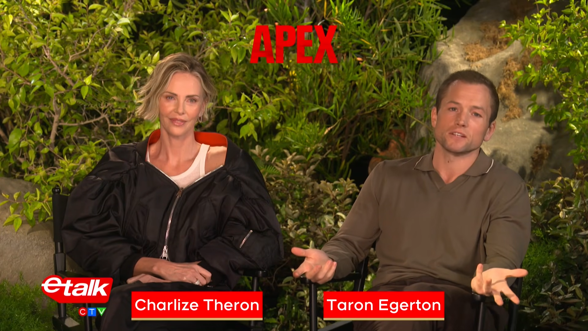 Two hosts sit in folding chairs outdoors among lush greenery, a bold red APEX logo above, as they speak in an ETalk interview segment with red name banners at the bottom (no names provided).