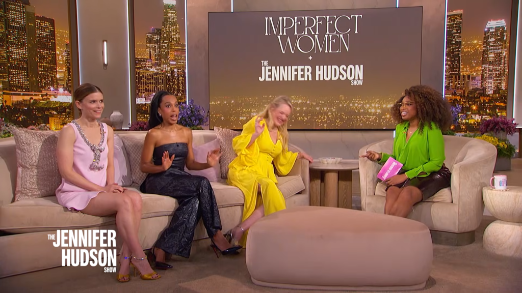 Four women sit on a beige couch on a talk-show set; large screen behind reads 'Imperfect Women' and 'The Jennifer Hudson Show'.