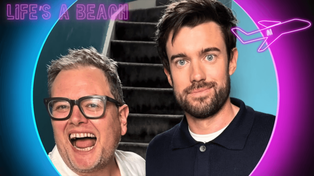 Two men smiling for a selfie in front of a stairwell, with a neon circular border and a pink airplane graphic in the corner.