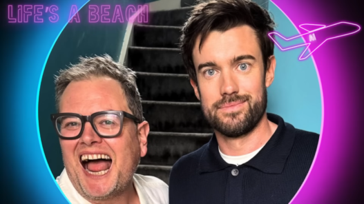 Two men smiling for a selfie in front of a stairwell, with a neon circular border and a pink airplane graphic in the corner.