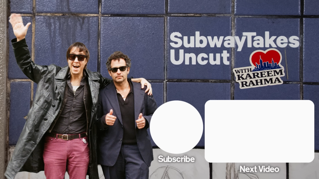 Two men posing and smiling in front of a blue tiled wall with a 'Subway Takes Uncut' sign and Kareem Rahma sticker, one waving.