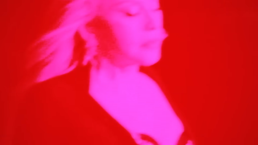 Abstract pink profile of a person against a red background, artistic lighting.