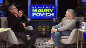 Two podcast hosts sit in armchairs facing each other, smiling and talking, with a blue sign reading 'ON PAR WITH MAURY POVICH' behind them and a rack of golf balls between.