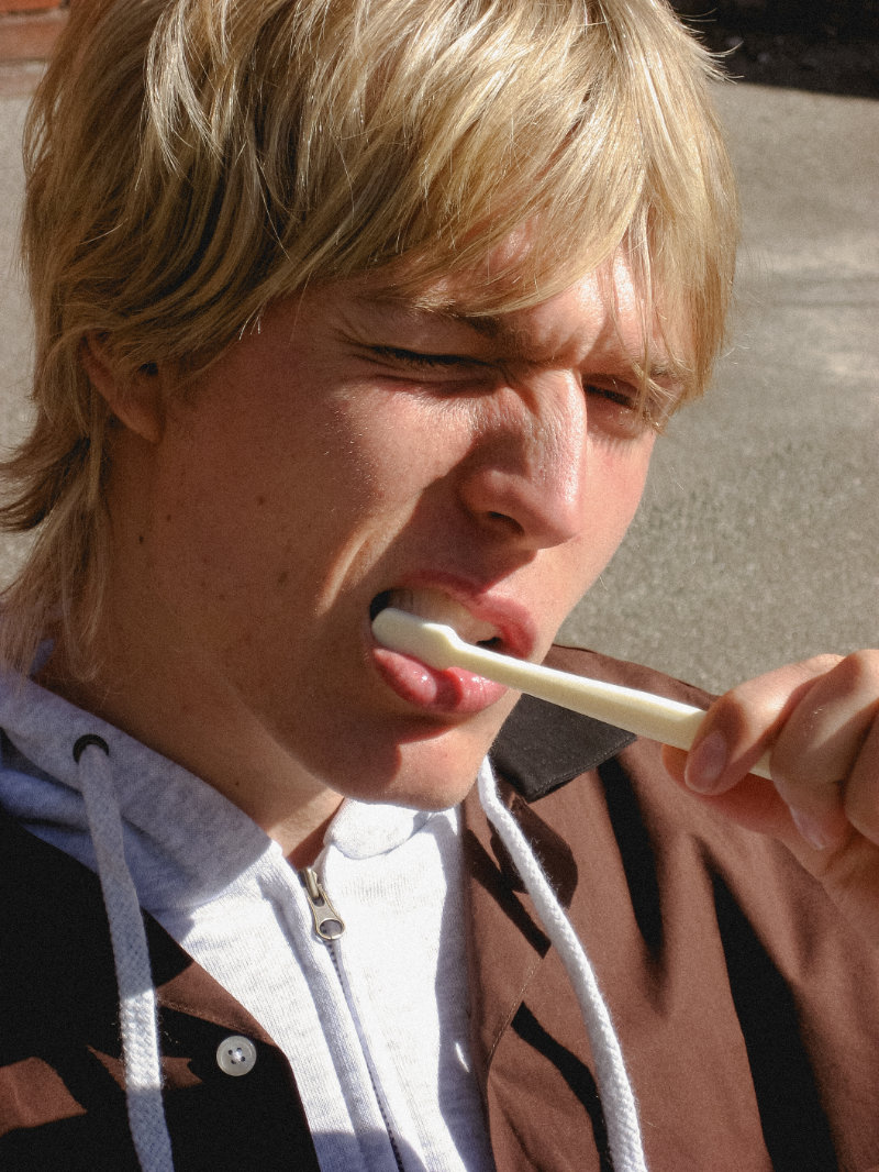Model Oskar Ø in a clean urban portrait photographed by Andrea Brandt.