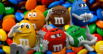 Five anthropomorphic M&M characters posing and lounging on a pile of colorful candies.