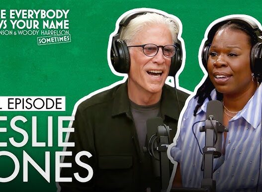 Podcast thumbnail featuring Leslie Jones and a male host wearing headphones and speaking into microphones on a green background (episode title: Full Episode Leslie Jones)