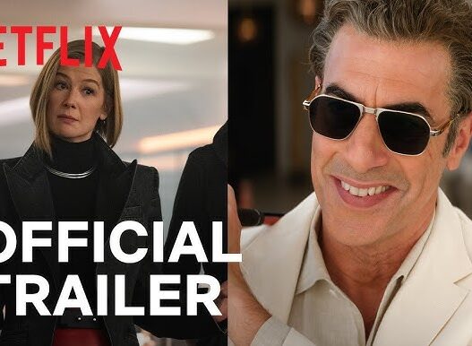 Netflix Official Trailer banner showing a woman in black on the left and a smiling man in sunglasses on the right.