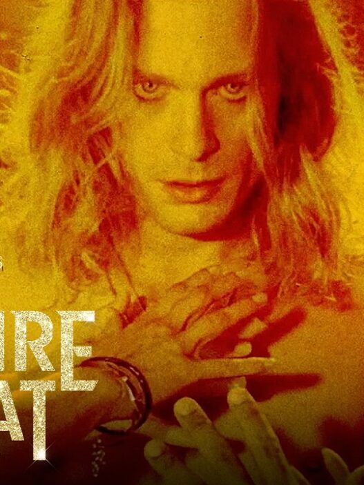 Promotional AMC+ poster for The Vampire Lestat featuring a pale man with outstretched hands in a red-orange glow.